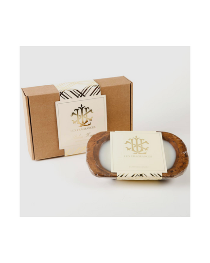 The 3 Wick Dough Bowl Candle - Italian Linen by Lux Fragrances sits in a rustic brown dough bowl, exuding charm. It comes in a cardboard box, adorned with elegant gold and black branding and a matching label, for a truly sophisticated presentation.